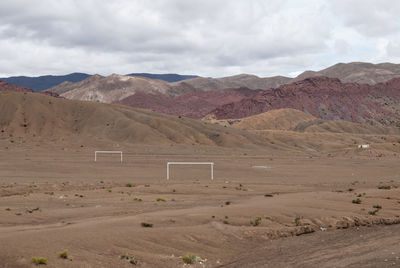 Scenic view of rocky mountains against cloudy sky