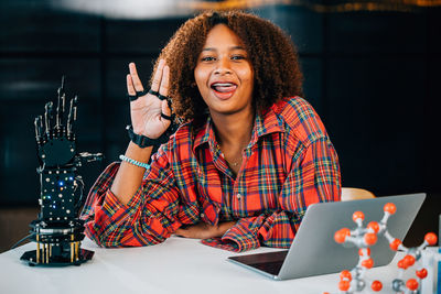 Portrait of young woman using digital tablet