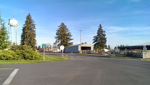 Empty road with buildings in background