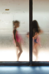 Full length of woman standing on bench