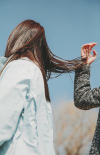 Cropped image of woman standing by friend