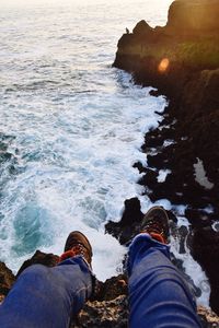 Low section of people on rock in sea