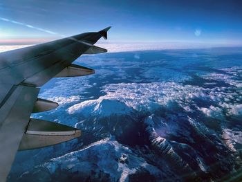 Aerial view of aircraft wing against sky