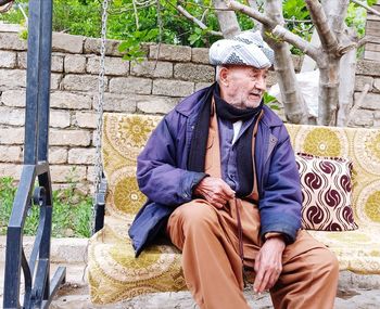 Portrait of senior man sitting outdoors