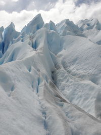 Scenic view of snow covered mountains against sky