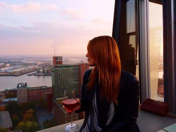 Woman in city at sunset