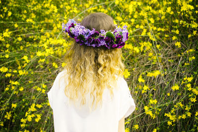 Rear view of woman standing on field