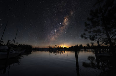 Scenic view of lake against sky at night