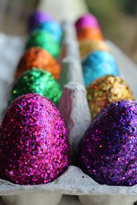 Close-up of colorful shiny easter eggs in crate