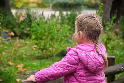 Side view of young woman looking at park