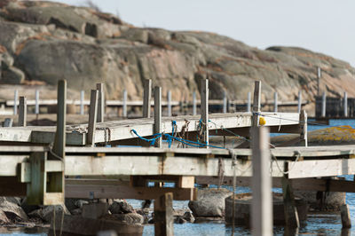 Lounge chairs on rocks against sky