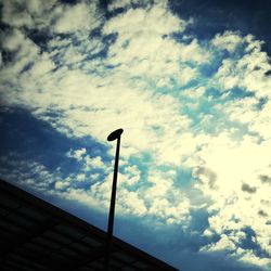 Low angle view of street light against cloudy sky