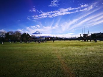 People on field against sky