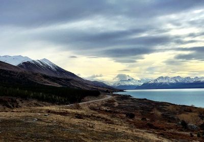 Scenic view of mountains against cloudy sky