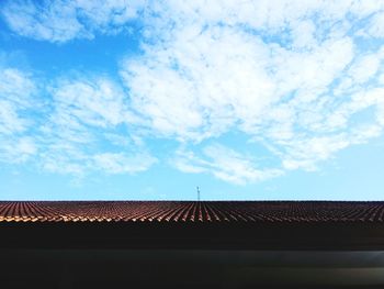 Low angle view of house roof against sky