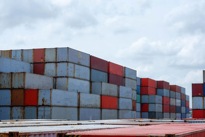 Stack of pier by building against sky