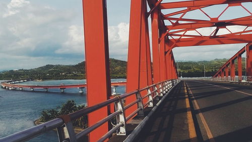 Bridge over mountain against sky