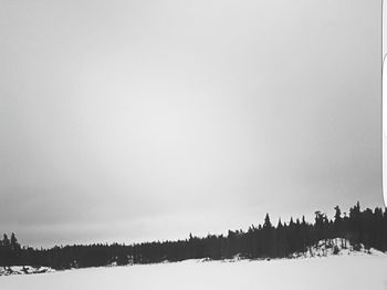 Snow covered landscape against sky