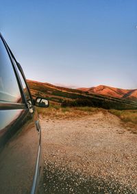 Car on road against clear blue sky
