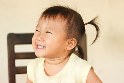 Close-up portrait of cute girl looking away