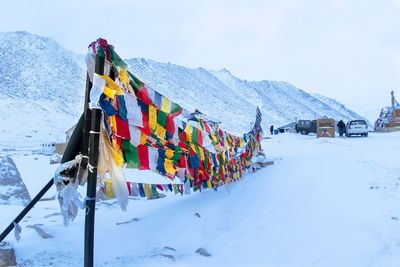 Colorful flags hanging on snowed landscape