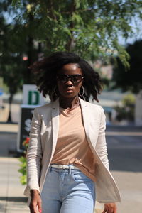 Young woman wearing sunglasses in city