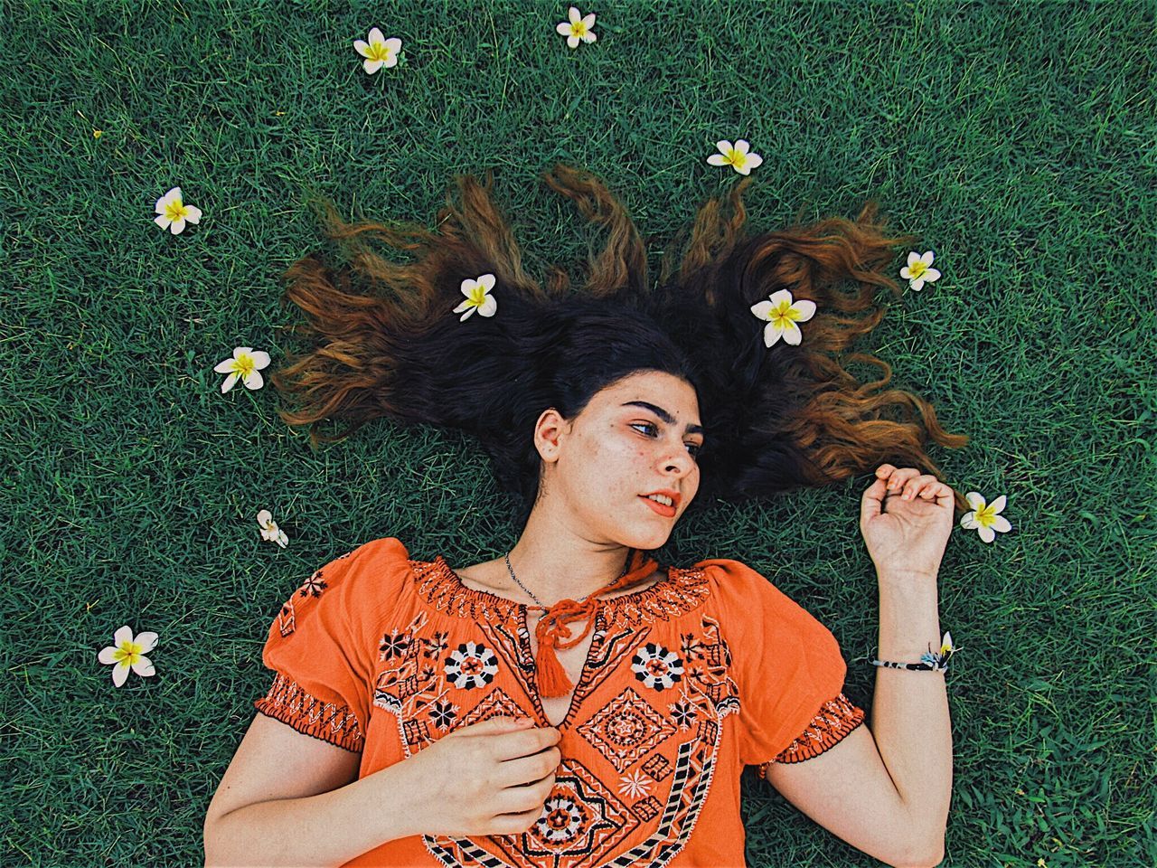 flower, only women, grass, beautiful woman, lying down, one woman only, adults only, adult, nature, one person, high angle view, lying on back, people, one young woman only, directly above, young adult, beauty, wearing flowers, portrait, young women, beautiful people, summer, day, freshness, women, outdoors, fragility, human body part, beauty in nature, laurel wreath, flower head