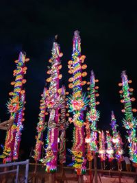 Low angle view of illuminated decoration hanging at night