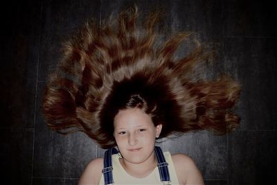 Portrait of cute girl against wall