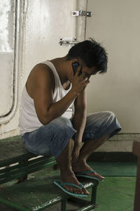 Young man sitting on floor