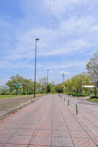 Empty road against cloudy sky