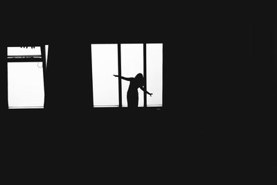 Silhouette man standing in corridor