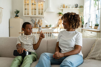 Portrait of smiling family sitting at home