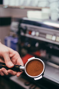 Close-up of hand holding coffee cup