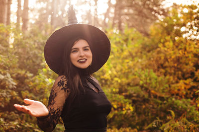 Portrait of a smiling young woman in forest