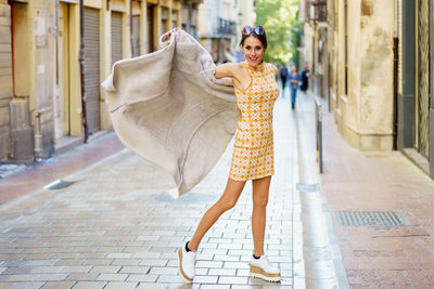 Full length of young woman walking on street