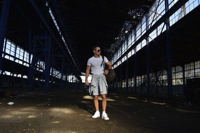 Full length of young man standing in abandoned factory