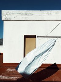 White textile hanging against built structure