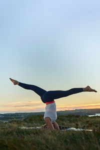 Full length of woman jumping against clear sky