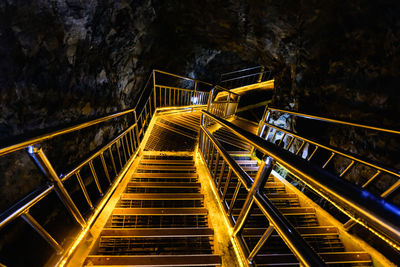 Bridge illuminated by lights in a cave