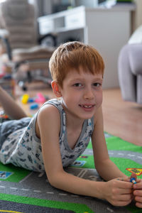 Young child boy plays constructor at home on the floor. preschool education. home fun. 