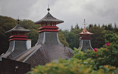 View of destillery pagodas against sky