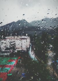 Woman seen through wet window in rainy season
