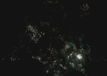 Low angle view of firework display at night