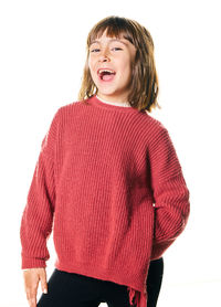 Portrait of young woman standing against white background