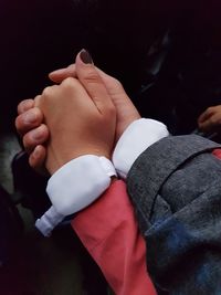 Close-up of couple holding hands