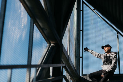 Man standing by railing