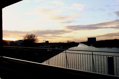 Scenic view of city against sky during sunset