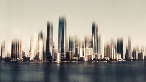 Panoramic view of modern buildings in city against sky