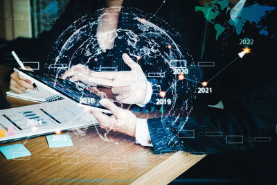 Digital composite image of businessman working in office